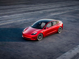 Automóvil Tesla rojo en autopista
